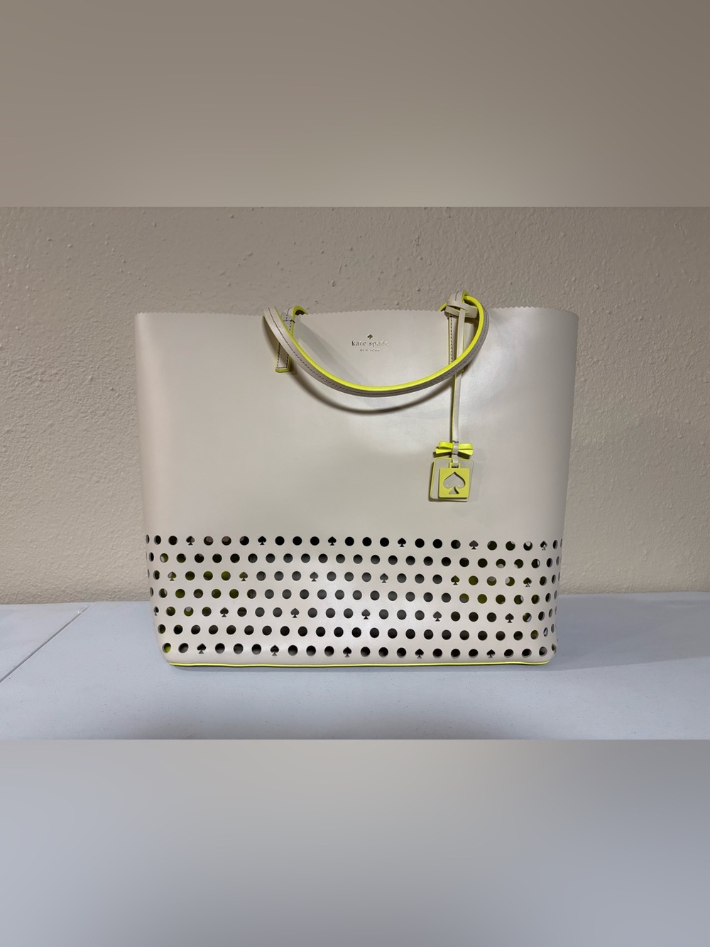 kate spade Cream Tote with Neon Yellow Trim and Perforated Base Len Ivy Drive